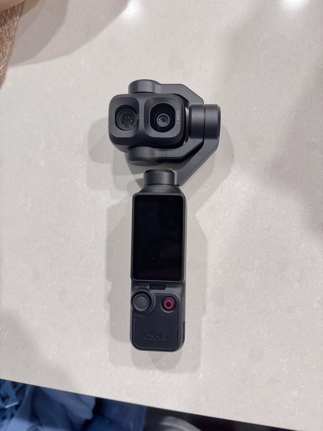 Reference photo of the DJI Osmo Pocket 4P standing on a countertop
